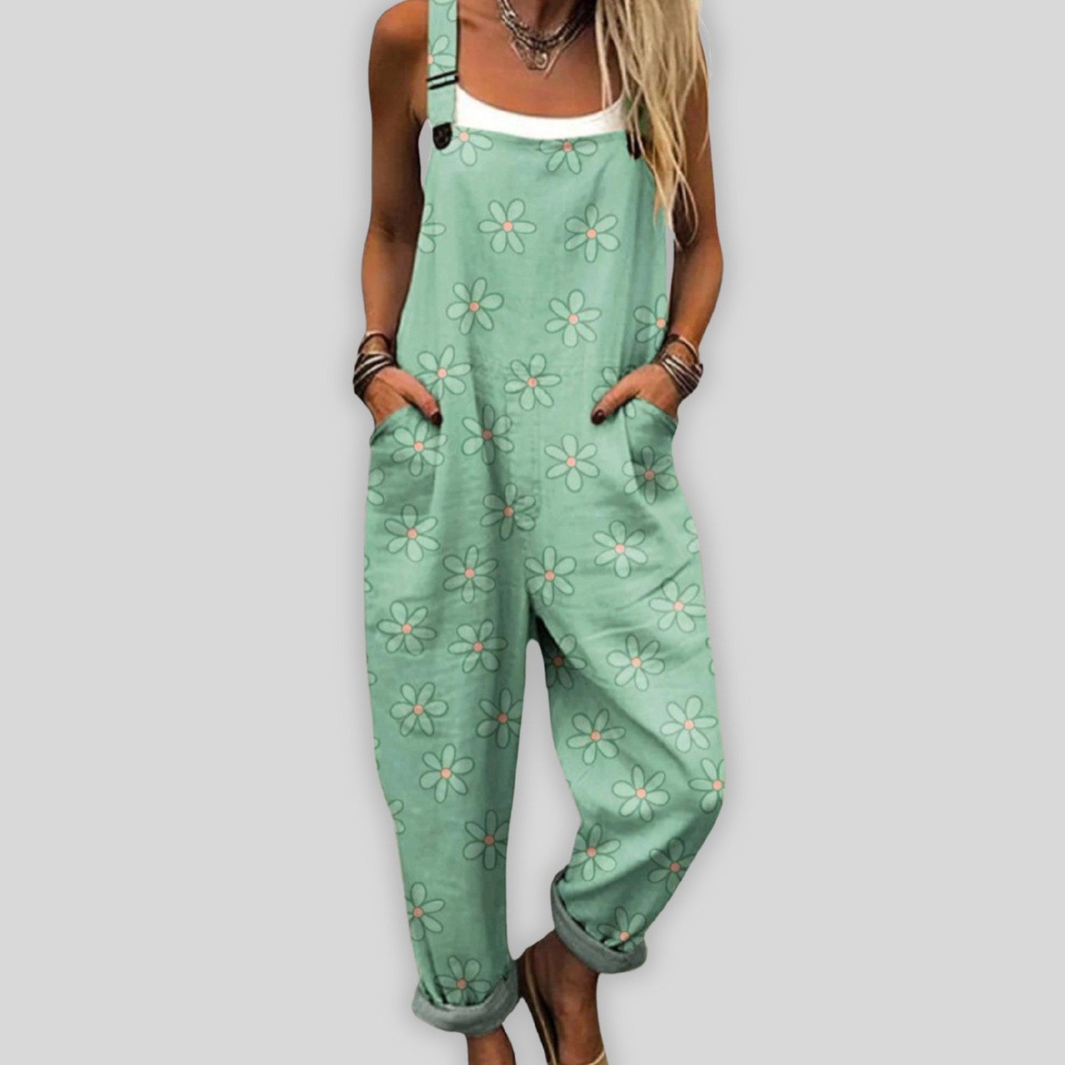 Green floral overalls worn by a person on a plain background